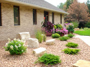 Extensive waterproofing and drainage went into this heavy clay site.  We installed the plants high so they would not drown.  Laurie designed the project, she also does the annual flowers each year.